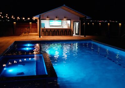 Swimming Pool and Spa Combo with Tiki Bar at Night - Pueblo, CO